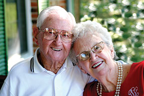 Photo of a man and woman smiling for a picture. 